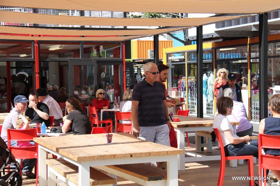 Shoppers rest inside a Shopping Mall built with pop-up shipping containers in central Christchurch, New Zealand, on Dec. 3, 2011.