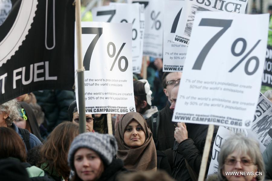 Protestors march during a climate change demonstration in central London, Britain, Dec. 3, 2011.