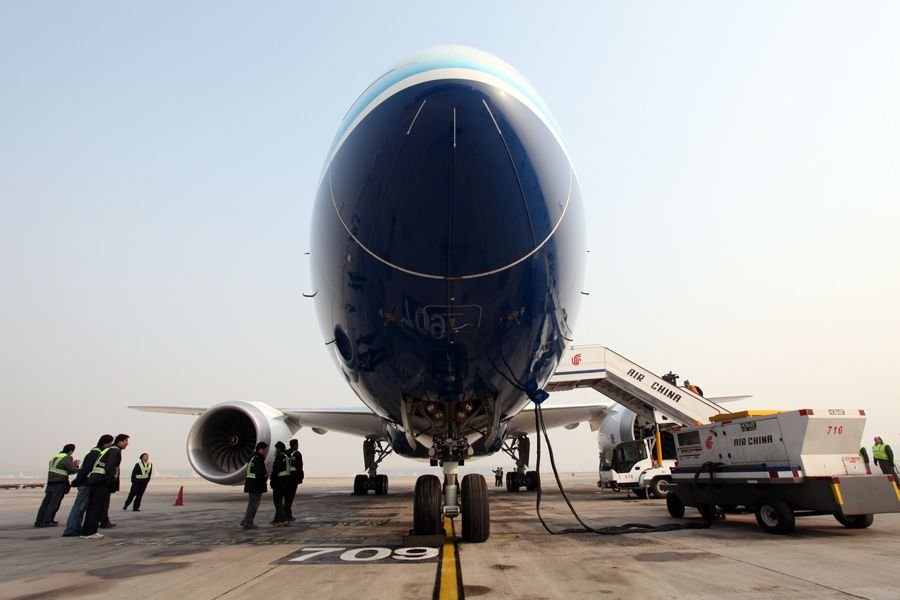 A Boeing 787 Dreamliner is seen parking at the tarmac of the Beijing Capital International Airport, Beijing, China, Dec. 4, 2011. The Boeing 787 Dreamliner arrived here Sunday, kicking off its six-month tour exhibition worldwide. [Yang Le/Xinhua]