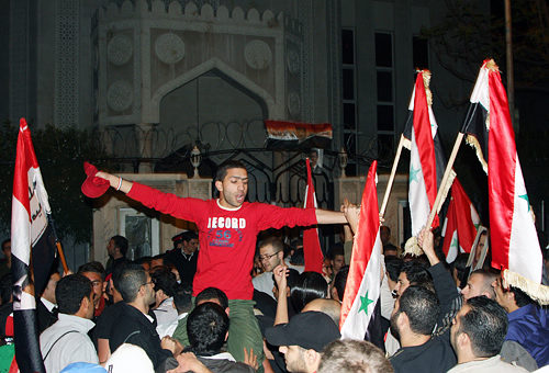 Syrians hold a demonstration on November 12 in front of the Qatari Embassy in Damascus to protest the Arab League's decision to suspend Syria's membership (XINHUA)