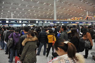 Passengers wait in the Terminal 3 at the Beijing Capital International Airport, Dec 4, 2011. [Photo/Xinhua] 