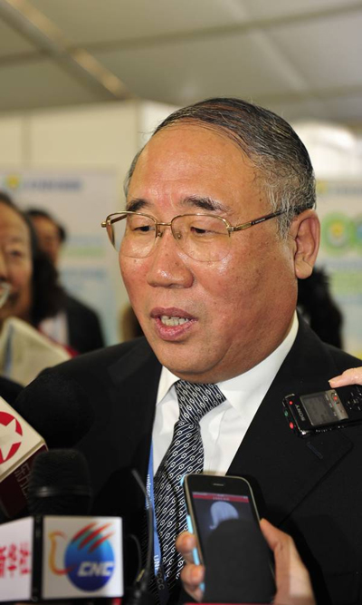 Xie Zhenhua, deputy director of the National Development and Reform Committee, speaks with reporters. [China.org.cn]