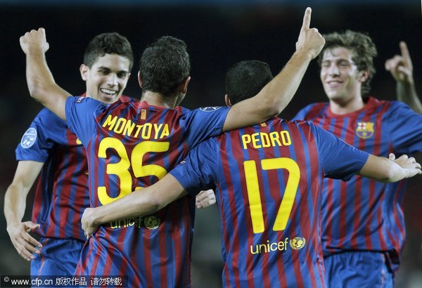 FC Barcelona's player Matin Montoya (2nd-L) celebrates with his teammates after scoring their team's second goal during the Champions League group H soccer match between FC Barcelona and Bate Borisov at the Nou Camp stadium in Barcelona, north-eastern Spain, 06 December 2011. 