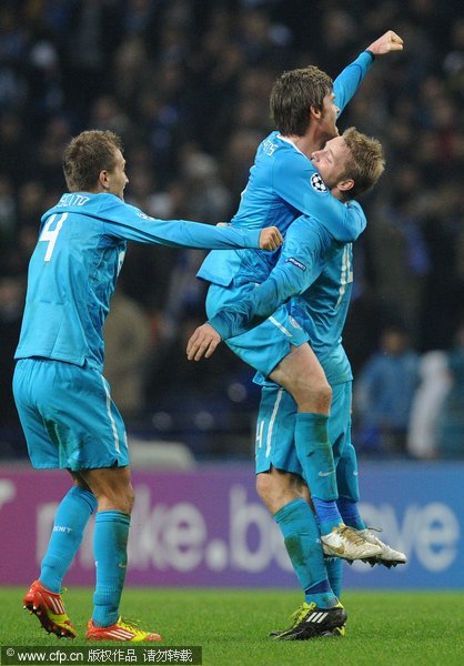 FC Zenit ST Petersburg's Nicolas Lombaerts from Belgium, Tomas Hubocan from Slovakia and Domenico Criscito from Italy, (from right to left) celebrate after their 0-0 draw against FC Porto during their Champions League Group G match at the Dragao Stadium, Porto, Portugal on Tuesday Dec. 6, 2011. 