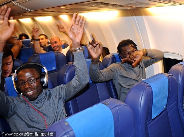 Lyon players are celebrating on their flight after an unlikely 7-1 win over Dinamo Zagreb in UEFA Champions League on December 8, 2011.