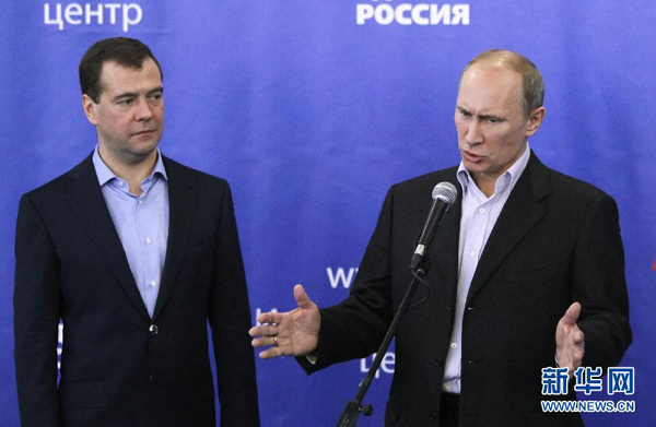 Russian President Dmitry Medvedev (L) and Prime Minister Vladimir Putin meet members of the United Russia party and its supporters at the party's headquarters in Moscow, Russia, Dec. 4, 2011, after the conclusion of the country's sixth parliamentary elections. 