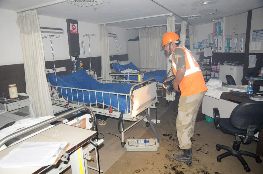 A firefighter checks a room in AMRI hospital after it catches fire in Kolkata, Dec. 9, 2011. Medical staff fled as flames and smoke filled an Indian hospital in the eastern Indian city of Kolkata early Friday, abandoning their patients to a fire that killed 89 people. Police arrested six hospital officials on charges of culpable homicide.