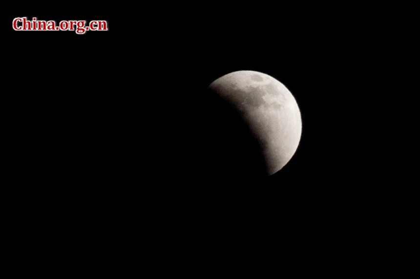 Photo taken around 21:20, Dec. 10, 2011 in Beijing shows that more than half of the moon is blocked by the Earth shadow cast on the lunar surface. [Pierre Chen / China.org.cn]