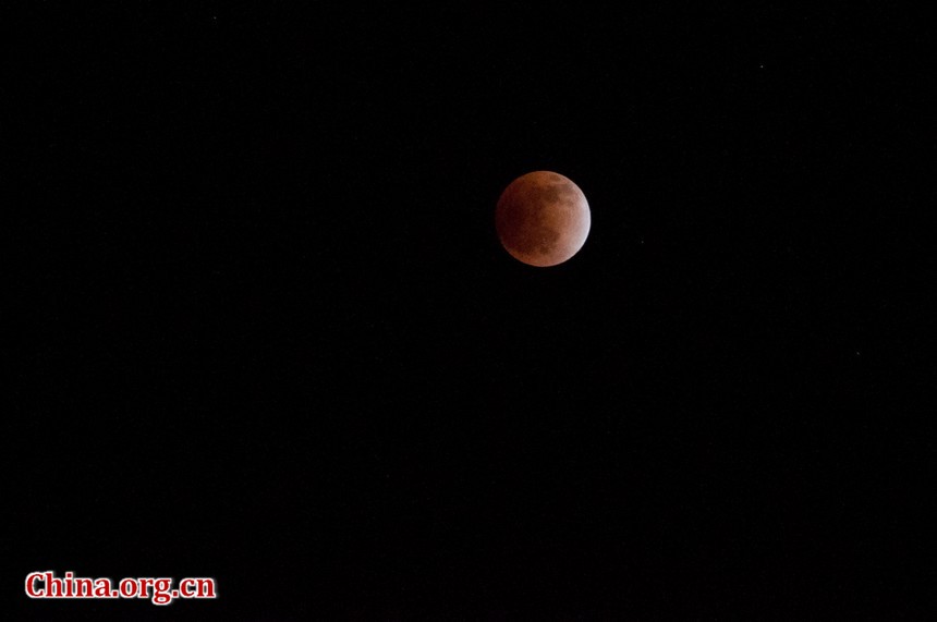 The indirect sunlight can still illuminate the Moon, putting it into a dramatic shade of red. [Pierre Chen / China.org.cn]