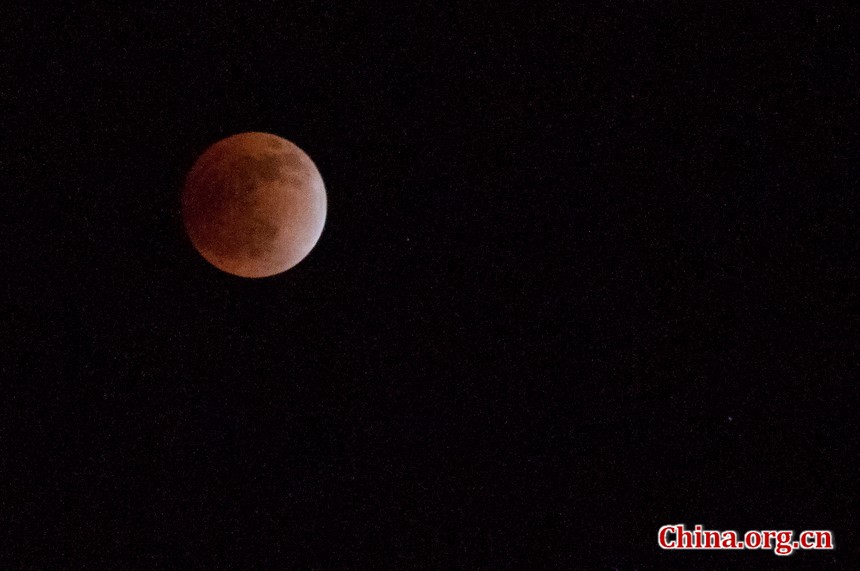 The indirect sunlight can still illuminate the Moon, putting it into a dramatic shade of red. [Pierre Chen / China.org.cn]