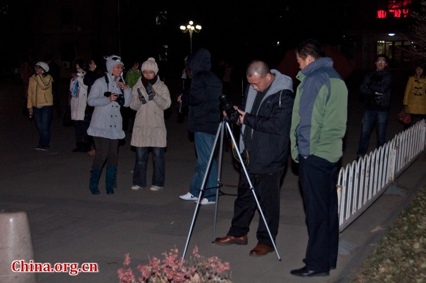 Stargazers and fans in Capital Normal University in Beijing are using tripods to hold their cameras steady so as to avoid the blurry in filming the lunar eclipse. [Pierre Chen / China.org.cn]