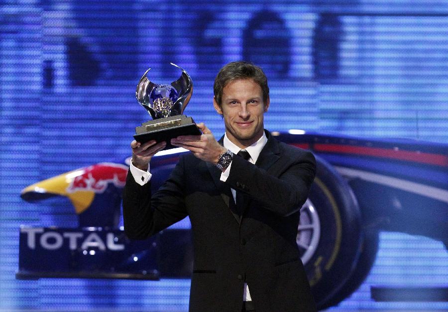 Jenson Button holds a trophy awarded at the annual FIA prize-giving gala in Delhi, Dec. 9, 2011. Button finished second in the standings. (Xinhua/Reuters Photo)