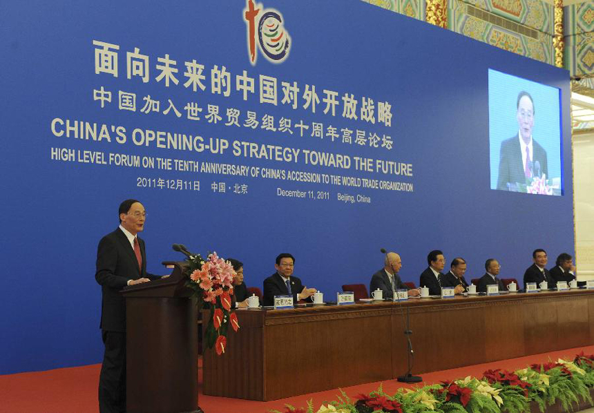 Chinese Vice Premier Wang Qishan (L) delivers a speech during the high level forum on the 10th anniversary of China's accession to the World Trade Organization in Beijing, capital of China, Dec. 11, 2011. 