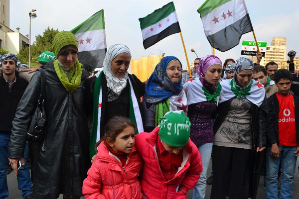 Syrian protestors shout slogans during a protest against Syria's President Bashar al-Assad in front of the Arab League headquarters in Cairo, Egypt, on Dec. 6, 2011.