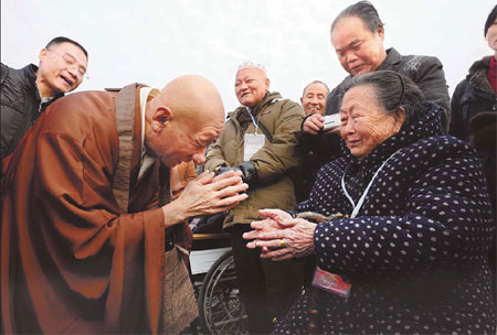 Japanese monk Shunan Noritake meets a survivor of the Nanjing Massacre on Tuesday. More than 5,000 people gathered at a museum in Nanjing, Jiangsu province, on the anniversary of the fall of the city to Japanese forces on Dec 13, 1937. In the six weeks following the city's fall more than 300,000 unarmed soldiers and civilians were killed by Japanese troops in what was then the Chinese capital. Photo by Lang Congliu / for China Daily 