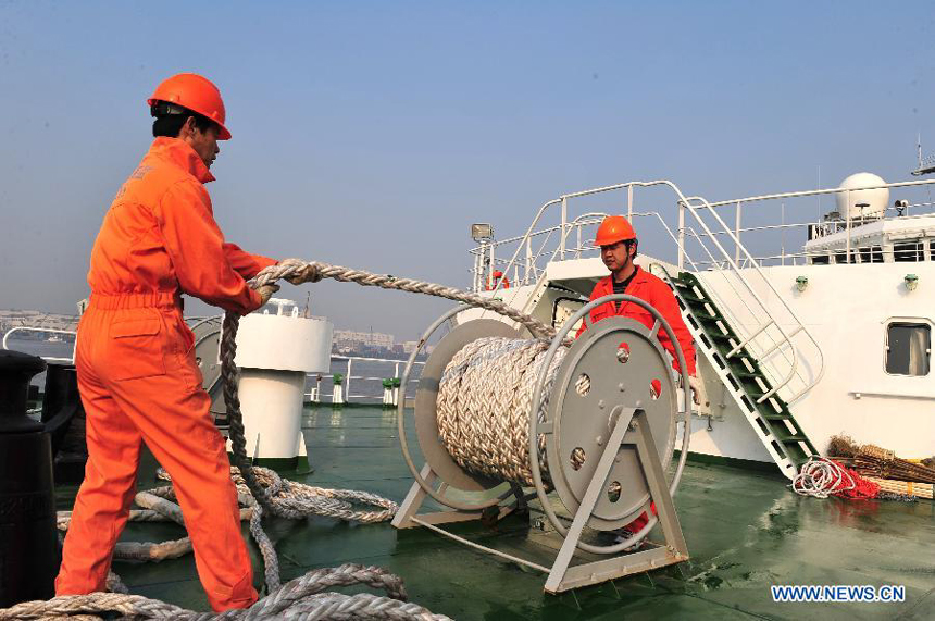 Crew members of 'China Haijian 50', the current most advanced vessel of China Marine Surveillance, prepare for departure in Shanghai, east China, Dec. 13, 2011. 'Haijian 50' set off from Shanghai Port of the State Oceanic Administration Tuesday for its maiden voyage. 