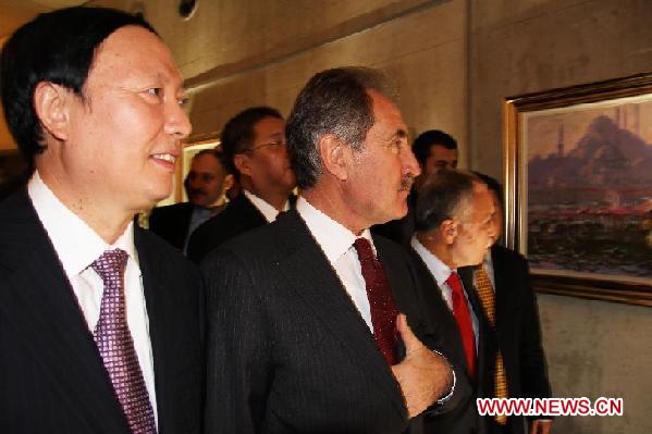 Turkish Minister of Culture and Tourism Ertugrul Gunay (2nd. L) and Chinese Vice Minister of Culture Yang Zhijin (1st. L) visit the opening exhibition of the '2012 China Culture Year' in Ankara, Turkey, Dec. 12, 2011. 