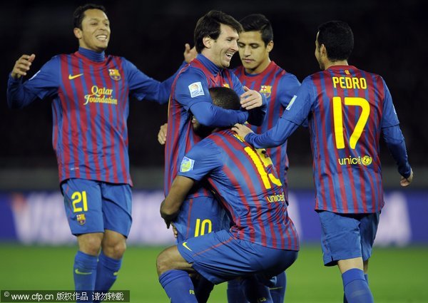 FC Barcelona forward Lionel Messi (C-L) is lifted by midfielder Seydou Keita (C-R) after a goal against Al-Sadd SC during their FIFA Club World Cup semifinal match at Yokohama International Stadium in Yokohama, near Tokyo, Japan, on Dec.15, 2011. 