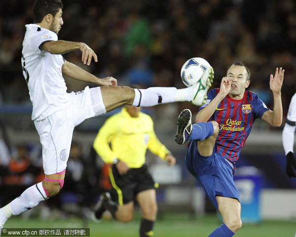  Spain's FC Barcelona midfielder Andres Iniesta (right) and Qatar's Al-Sadd sports club defender Ibrahim Abdulmajed vie for the ball during the FIFA Club World Cup semifinal match at Yokohama International Stadium in Yokohama, near Tokyo, Japan, on Dec.15, 2011.