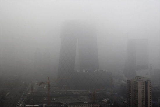 The new China Central Television headquarters building was seen enveloped in heavy fog in Beijing, capital of China on Monday, December 6, 2011. [CFP]