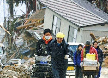 Japan: Residents of Rikuzentakata, Iwate prefecture, salvage belongings eight days after their homes were ruined by the earthquake and tsunami on March 11. [Agencies]