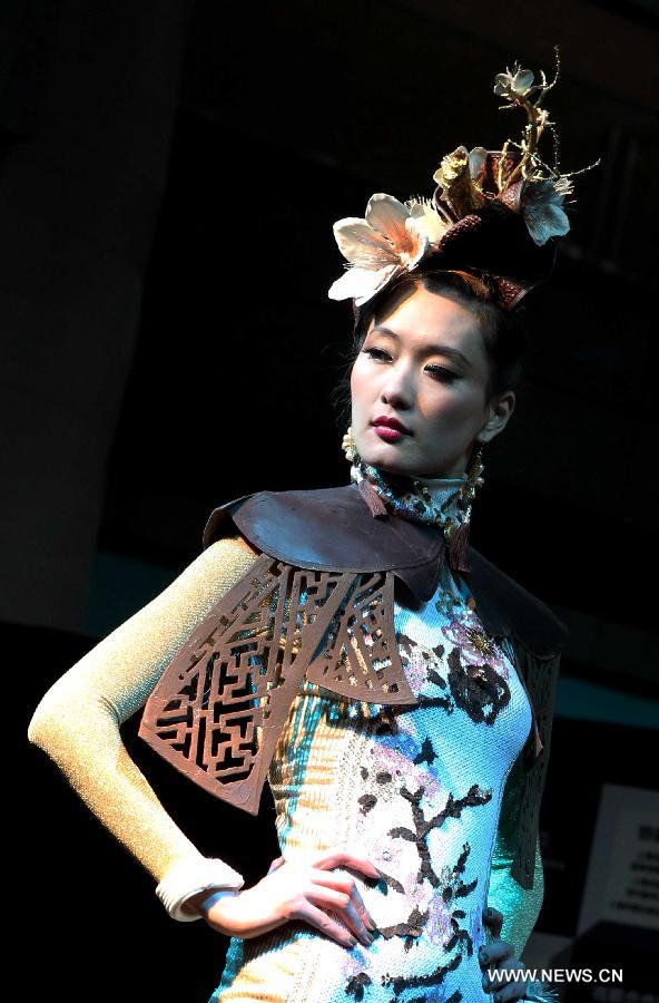 A model presents a creation made of chocolate during a chocolate fashion show at World Chocolate Wonderland in Shanghai, east China, Dec. 15, 2011. 