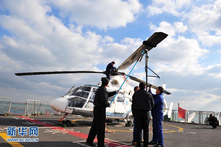 The crew is installing the rotor blades on the 'China Marine Surveillance B-7115' helicopter on Dec. 17, 2011. A regular joint sea and air patrol has been launched for the first time, involving 'China Marine Surveillance B-7115' helicopter and two ocean surveillance ships 'China Marine Surveillance 50' and 'China Marine Surveillance 66.' [Xinhua]