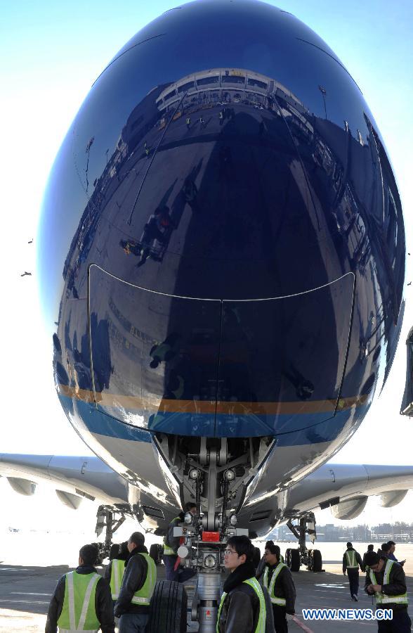 Photo taken on Dec. 18, 2011 shows an Airbus A380 landing at Capital International Airport in Beijing, capital of China. The second Airbus A380 ordered by China Southern Airlines arrived at the airport on Sunday after more than 10 hours' flight from France. 