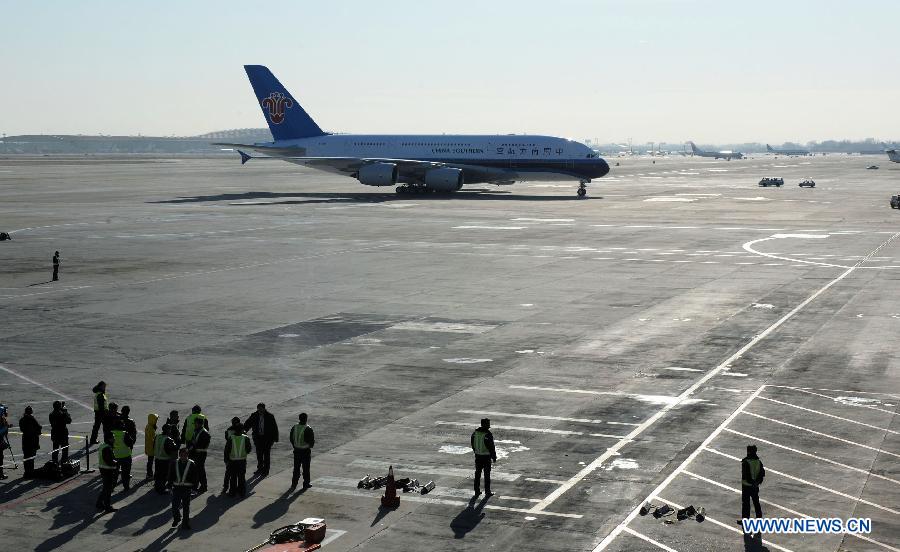 Photo taken on Dec. 18, 2011 shows an Airbus A380 landing at Capital International Airport in Beijing, capital of China. The second Airbus A380 ordered by China Southern Airlines arrived at the airport on Sunday after more than 10 hours' flight from France.