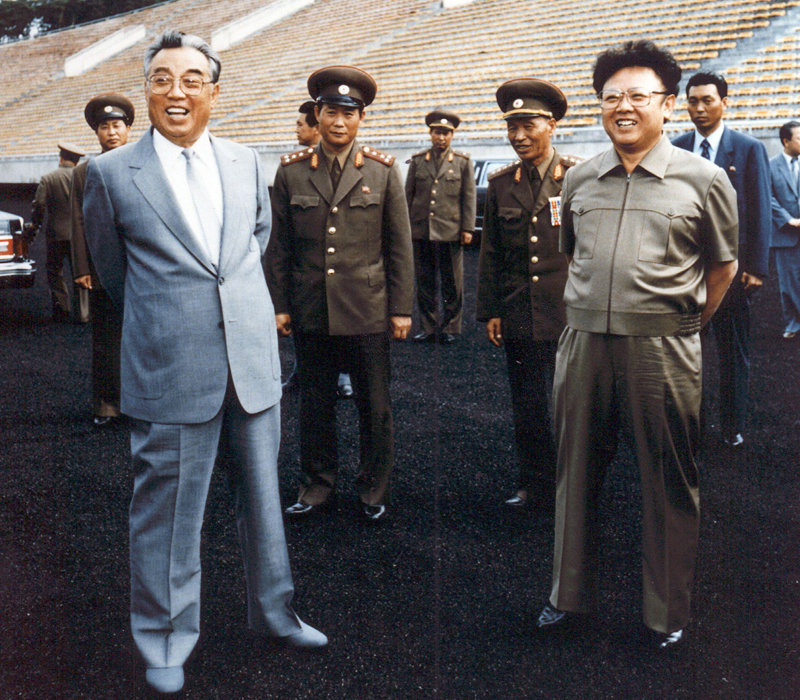 Kim Jong-il and his father. [File photo]