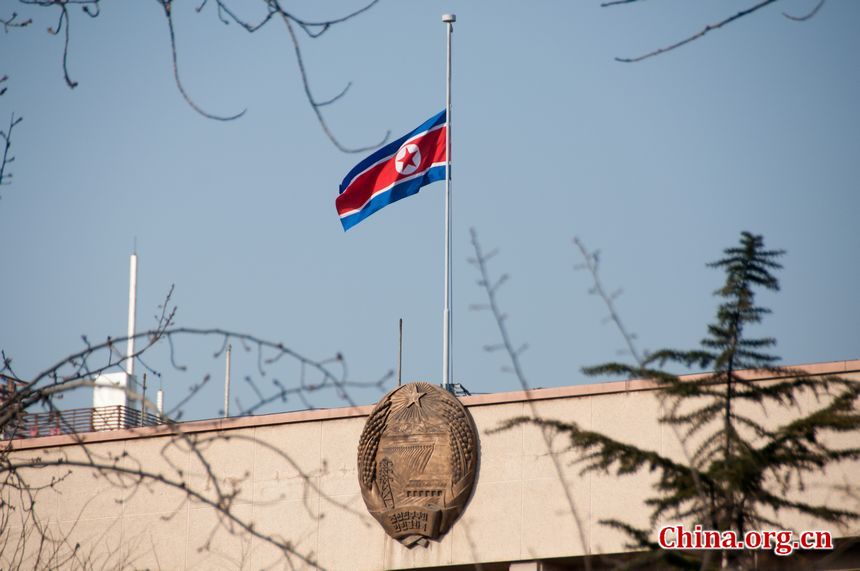 The national flag that the Embassy of the Democratic People's Republic of Korea is lowered at half-mast to mour the death of Kim Jong Il, Monday, December 19, 2011. [Maverick Chen / China.org.cn]