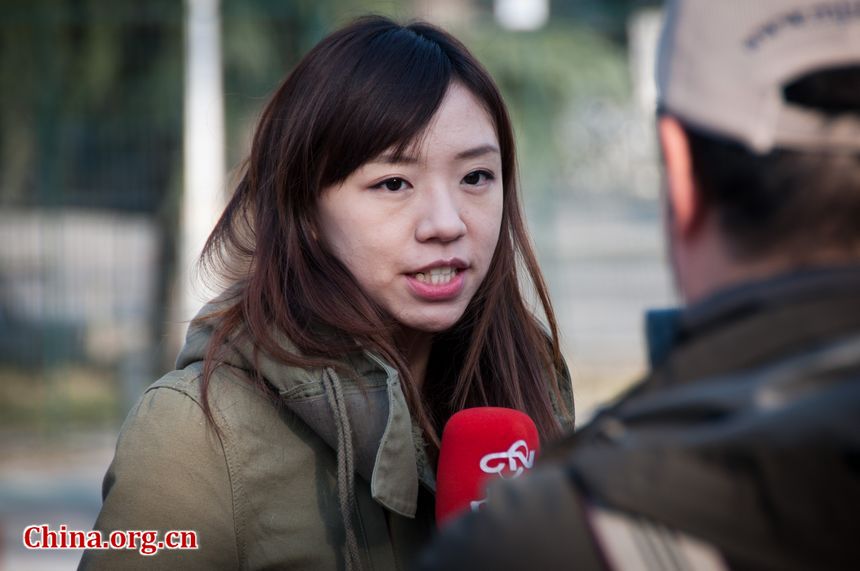 A reporter from Taiwan makes live broadcast before the DPRK embassy in Beijing on Monday, December 19, 2011, amid the news that Kim Jong Il, DPRK's top leader has died. [Maverick Chen / China.org.cn]