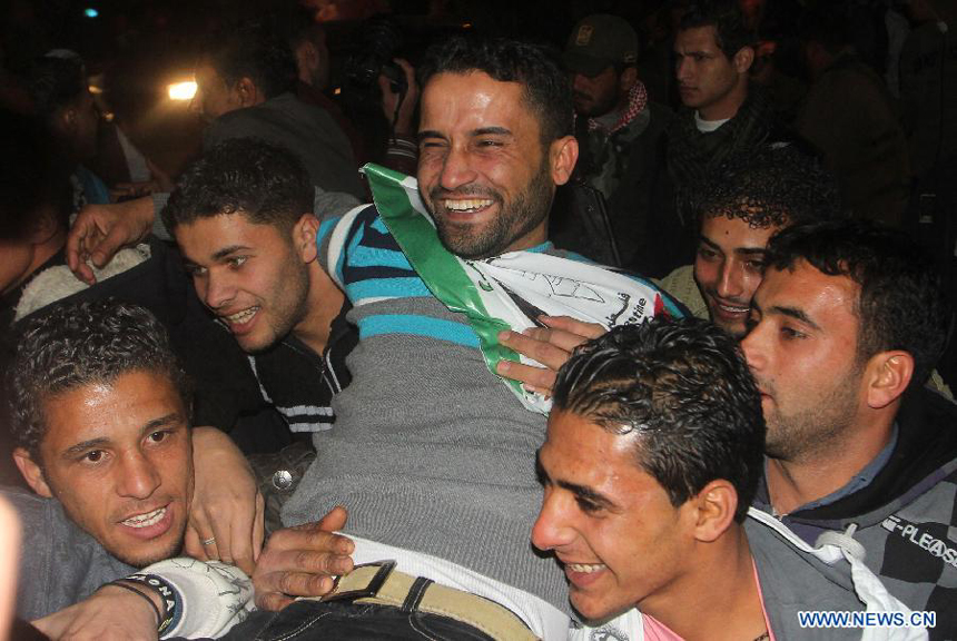 A freed Palestinian prisoner is greeted by relatives in Rafah border crossing in southern Gaza Strip on Dec. 18, 2011. Israel freed 550 Palestinian prisoners on Sunday evening in the second phase of a prisoner swap deal, while Hamas movement announced the Palestinian-Israeli agreement reached in October had been finalized.