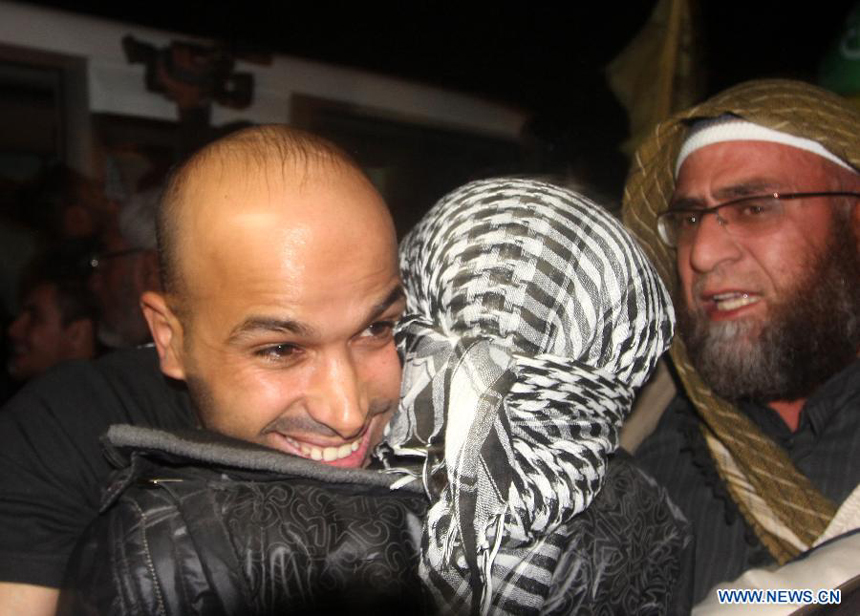 A freed Palestinian prisoner is greeted by relatives in Rafah border crossing in southern Gaza Strip on Dec. 18, 2011. Israel freed 550 Palestinian prisoners on Sunday evening in the second phase of a prisoner swap deal, while Hamas movement announced the Palestinian-Israeli agreement reached in October had been finalized.