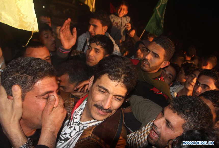 A freed Palestinian prisoner is greeted by relatives in Rafah border crossing in southern Gaza Strip on Dec. 18, 2011. Israel freed 550 Palestinian prisoners on Sunday evening in the second phase of a prisoner swap deal, while Hamas movement announced the Palestinian-Israeli agreement reached in October had been finalized.