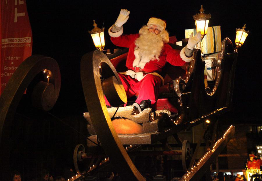 A man dressed as Santa Claus takes part in the Christmas float parade held in Nivelles, Belgium, Dec. 17, 2011. About 14 floats offered performance and candies to local residents and tourists Saturday night at the Christmas float parade in Nivelles.