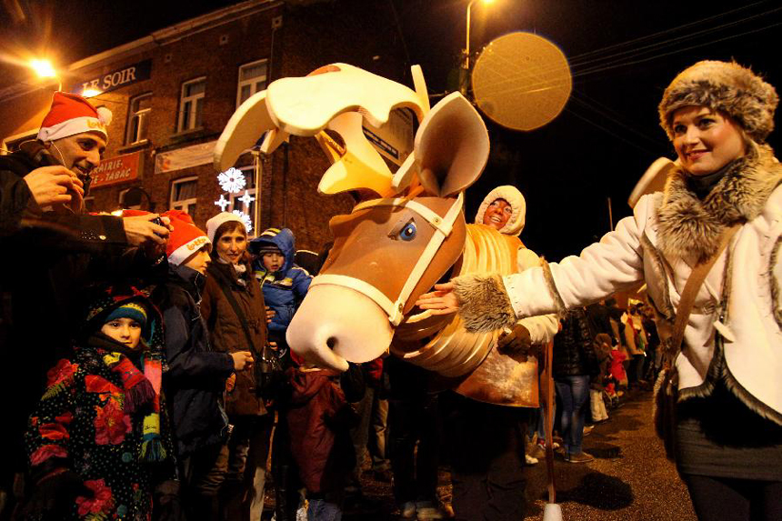 A girl with a reindeer take part in the Christmas float parade held in Nivelles, Belgium, Dec. 17, 2011. About 14 floats offered performance and candies to local residents and tourists Saturday night at the Christmas float parade in Nivelles. 