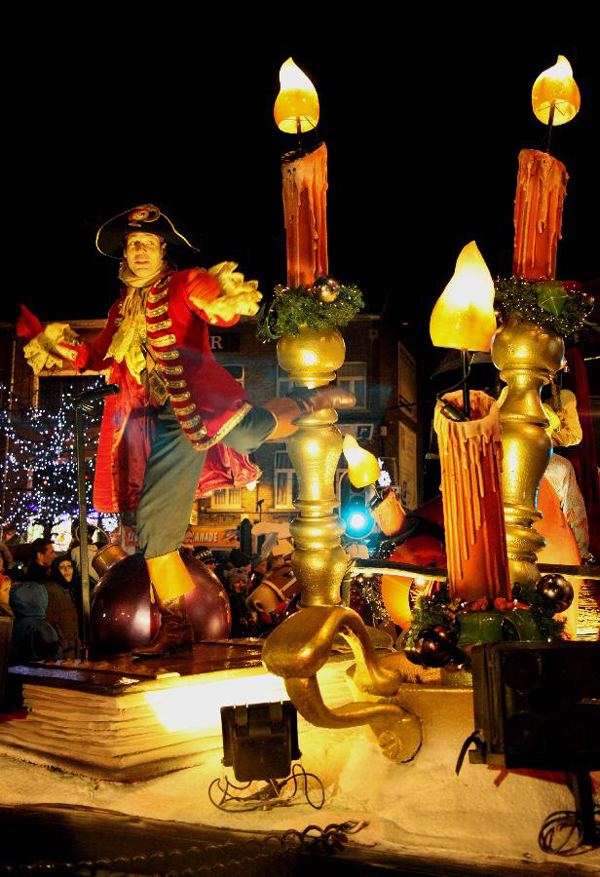 An actor takes part in the Christmas float parade held in Nivelles, Belgium, Dec. 17, 2011. About 14 floats offered performance and candies to local residents and tourists Saturday night at the Christmas float parade in Nivelles. 