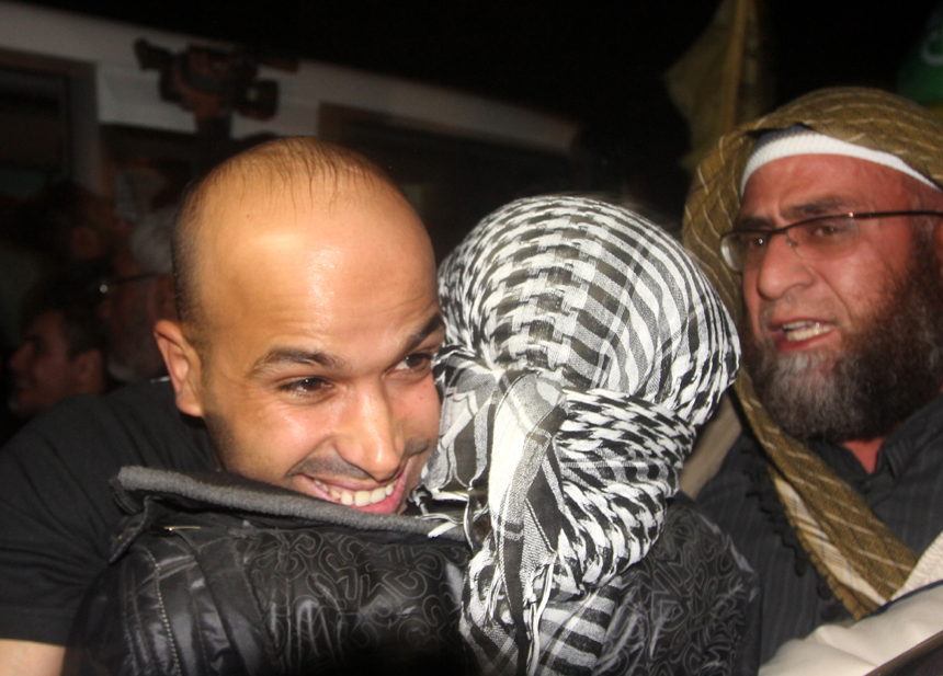 A freed Palestinian prisoner is greeted by relatives in Rafah border crossing in southern Gaza Strip on Dec. 18, 2011. Israel freed 550 Palestinian prisoners on Sunday evening in the second phase of a prisoner swap deal, while Hamas movement announced the Palestinian-Israeli agreement reached in October had been finalized.