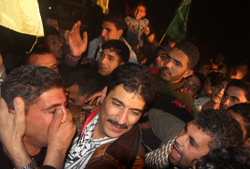 A freed Palestinian prisoner is greeted by relatives in Rafah border crossing in southern Gaza Strip on Dec. 18, 2011. Israel freed 550 Palestinian prisoners on Sunday evening in the second phase of a prisoner swap deal, while Hamas movement announced the Palestinian-Israeli agreement reached in October had been finalized. 
