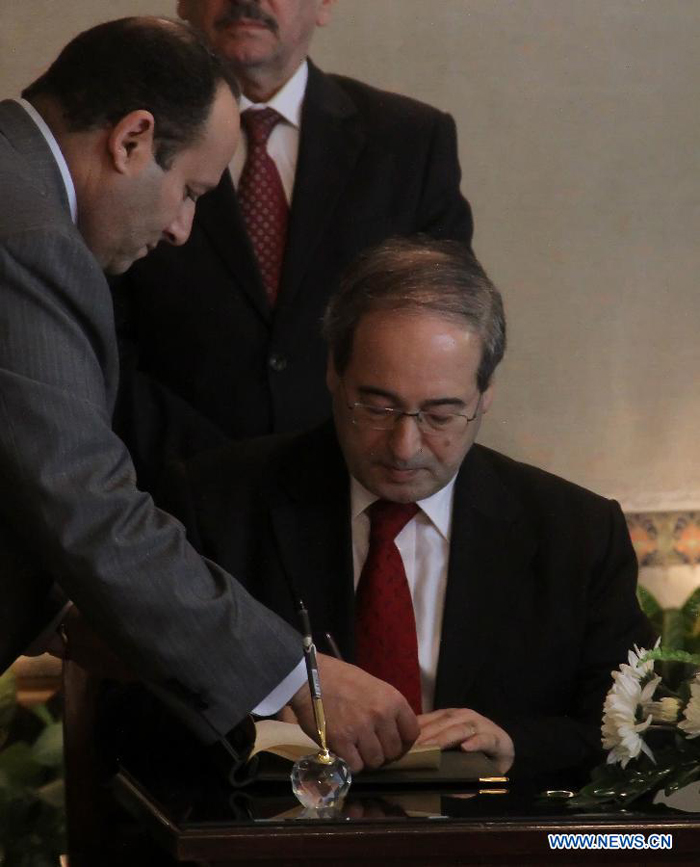 Syrian Deputy Foreign Minister Faisal Mekdad signs the Arab League (AL) observer deal at the AL's Headquarters in Cairo, Egypt, on Dec. 19, 2011.