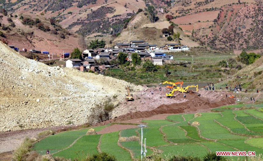 Excavators work at the spot of landslide in Yunlong County of the Dali Bai Autonomous Prefecture, southwest China's Yunnan Province, Dec. 18, 2011. The landslide, which occurred at 7:50 p.m. Saturday, has blocked the Bijiang River and formed a barrier lake, threatening hundreds of people. Authorities in Yunlong county are rushing to evacuate local residents and divert water from the river. 