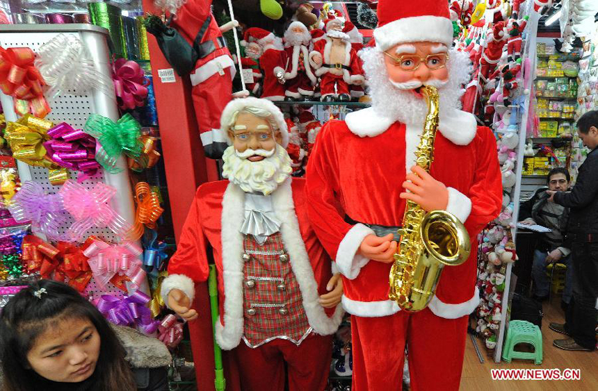 Businessmen are seen at a booth selling decorations for Christmas at the International Trade City in Yiwu, east China's Zhejiang Province, Dec. 18, 2011. 