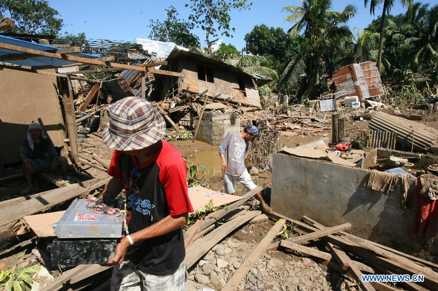 Residents recover reusable materials from their home after tropical storm Washi triggered flash floods in Cagayan De Oro, the Philippines, on Dec. 19, 2011. The death toll from tropical storm Washi has risen to 632, and hundreds more still missing. 