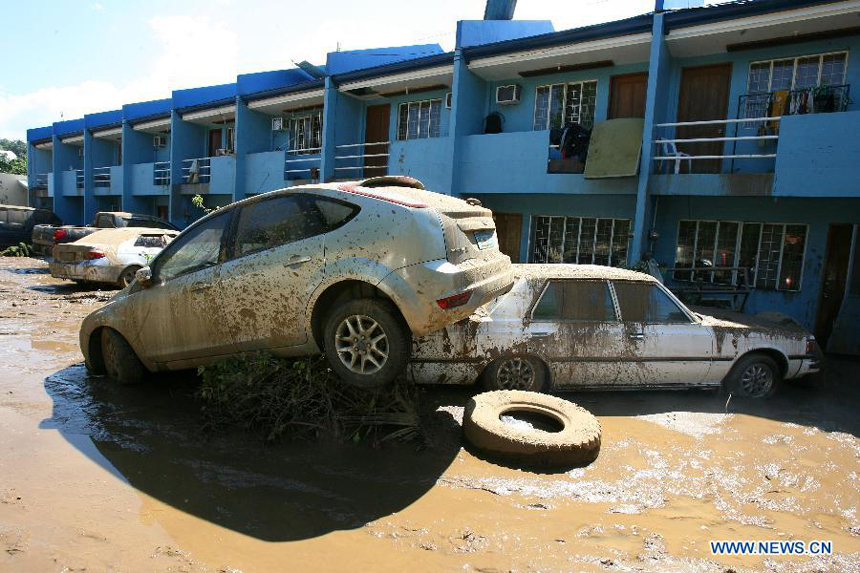 Cars rest on top of each other after tropical storm Washi triggered flash floods in Cagayan De Oro, the Philippines, on Dec. 19, 2011. The death toll from tropical storm Washi has risen to 632, and hundreds more still missing. 