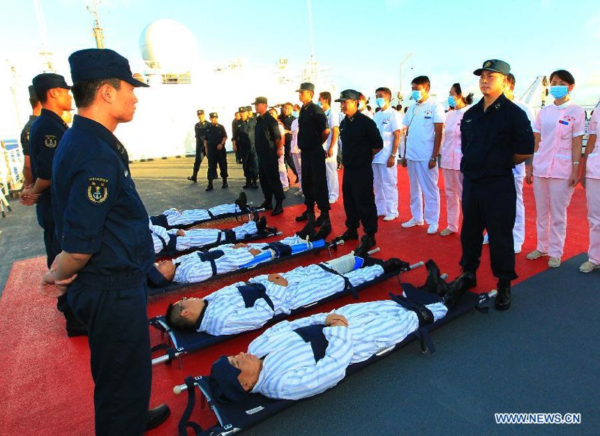 Medical members transfer the 'injured' soldiers to the escape platform on Chinese Navy hospital ship 'Peace Ark' during a drill in the Pacific on Dec. 19, 2011. The hospital ship 'Peace Ark' is on its way home after conducted humanitarian voyage 'Mission Harmony-2011' in the Latin American nations.