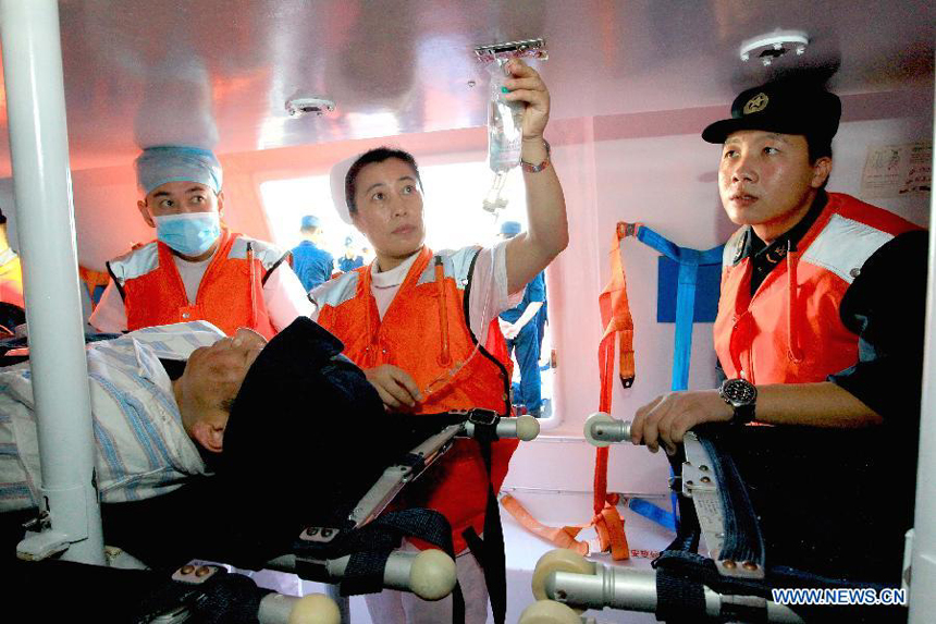 Medical members transfer an 'injured' soldier to the escape cabin on Chinese Navy hospital ship 'Peace Ark' during a drill in the Pacific on Dec. 19, 2011. The hospital ship 'Peace Ark' is on its way home after conducted humanitarian voyage 'Mission Harmony-2011' in the Latin American nations.