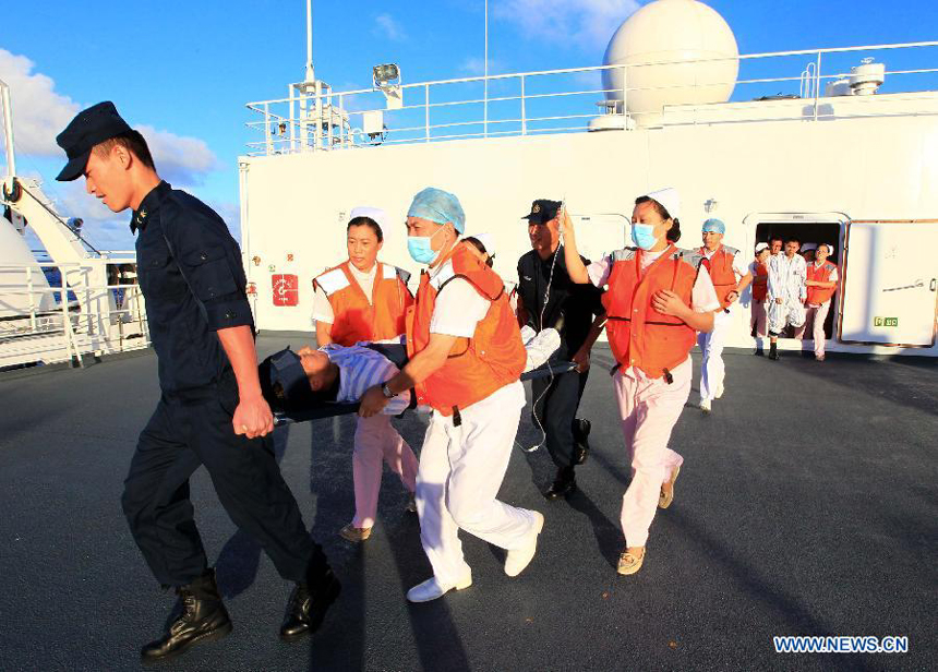 Medical members transfer an 'injured' soldier on Chinese Navy hospital ship 'Peace Ark' during a drill in the Pacific on Dec. 19, 2011. The hospital ship 'Peace Ark' is on its way home after conducted humanitarian voyage 'Mission Harmony-2011' in the Latin American nations. 