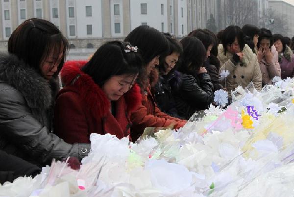 People mourn the death of Kim Jong Il, top leader of the Democratic People's Republic of Korea (DPRK), in Pyongyang, DPRK, Dec. 21, 2011. [Zhang Li/Xinhua]