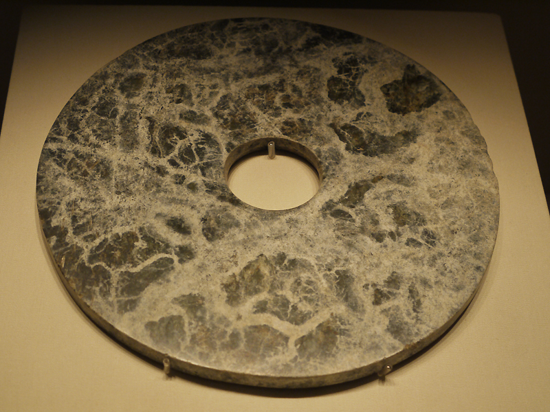 Jade Bi (disc), Liangzhu Culture (c. 3300-2200 BC), unearthed at Changming, Yuhang, Zhejiang Province, 1988. It is exhibited in the section of Life and Production in Neolithic China, an exhibition of Ancient China in the National Museum of China.[Photo by Xu Lin / China.org.cn]